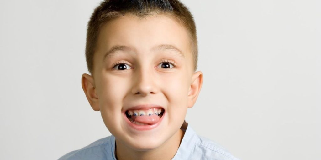 closeup shot of a boy with tongue outside